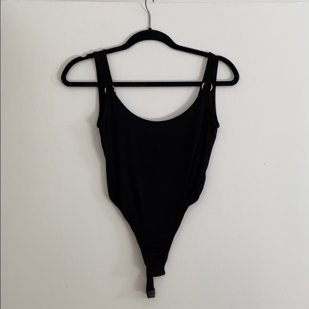 PrettyLittleThing black onesie w/ gold accents.